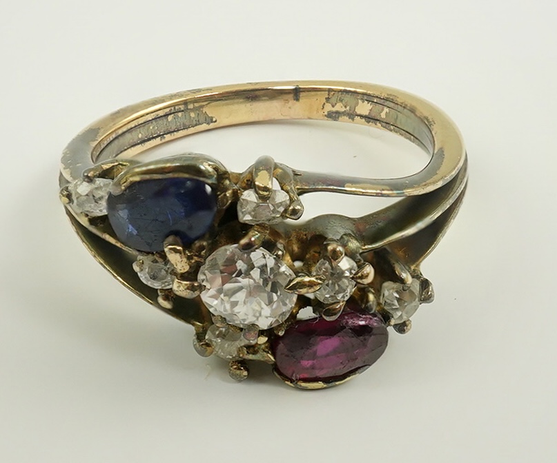 An early 20th century style gold, ruby, sapphire and diamond cluster set triple shank ring